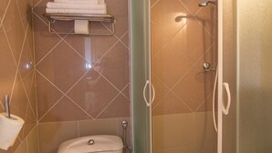 A bathroom with a toilet, a glass-enclosed shower, and a towel rack. - Pansion Saturn / Pansion Saturn 15 (Veli Lošinj)