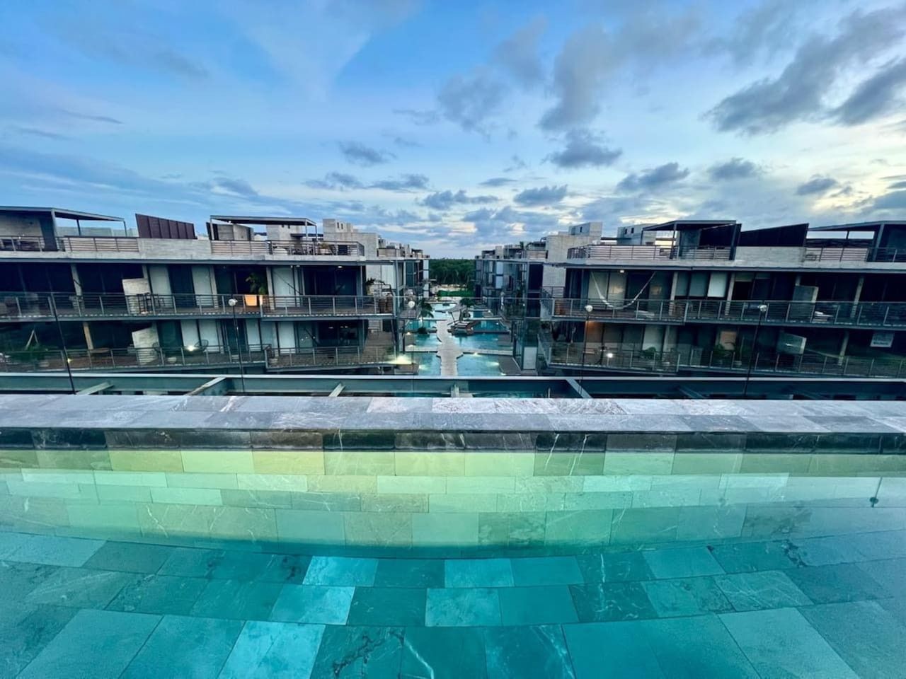 A swimming pool with a view of modern buildings in the background.