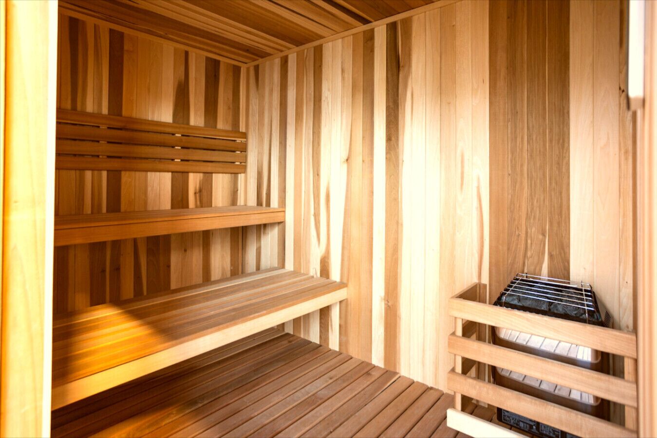 A wooden sauna with benches and a bench seat.