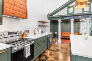 A kitchen with green cabinets, a stainless steel stove, and a white countertop. - Walk to everything Downtown Mobile, Pets Welcome 5 min walk to Regions Arena (Mobile)