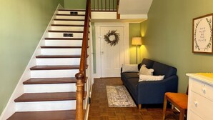 A staircase with wooden steps and a wooden handrail, leading to a door with a 'No Guest Access' sign. - Sunlit Studio on Historic Main Street (Palmyra)
