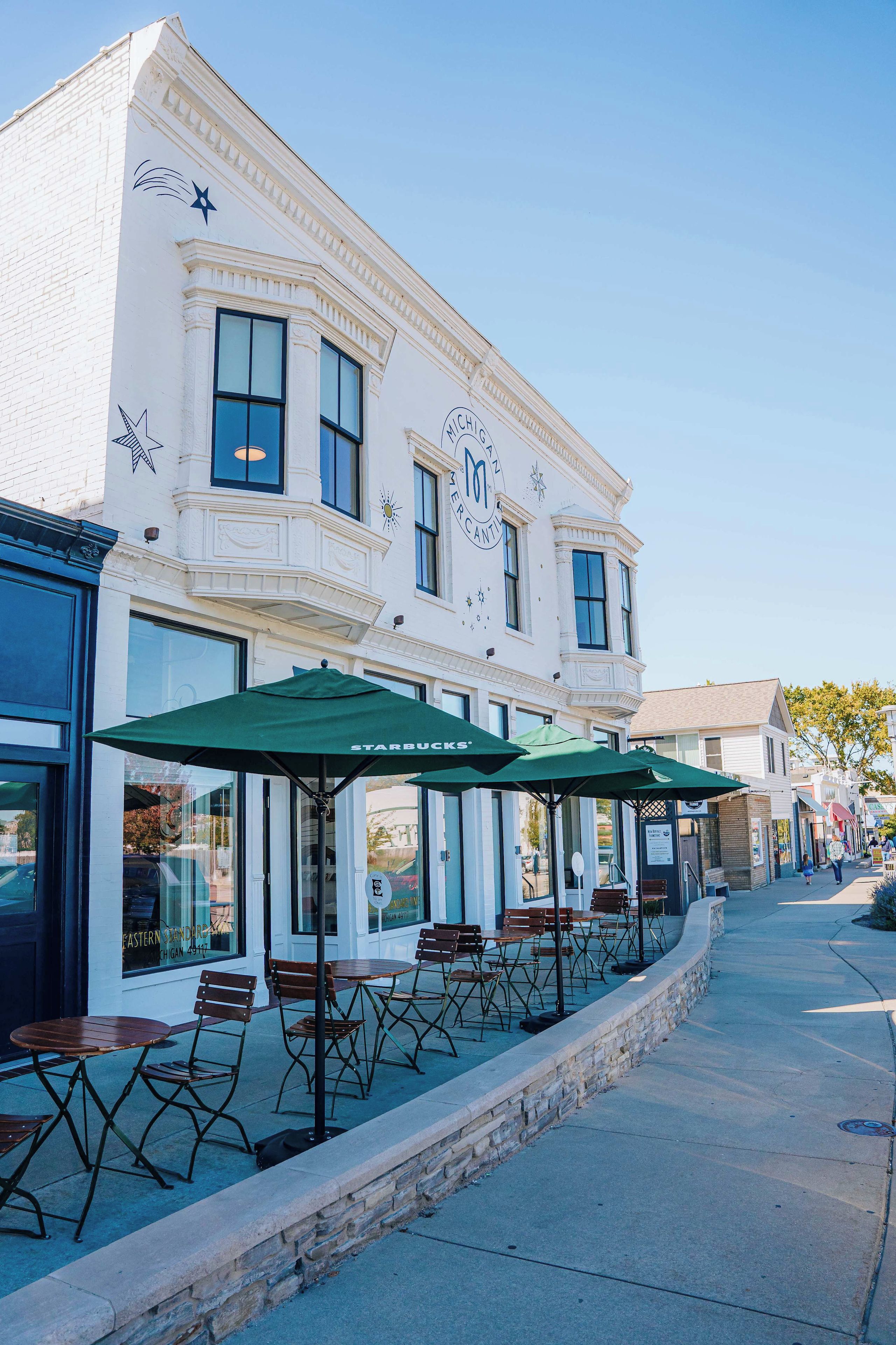 A building with a storefront and outdoor seating area.