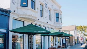 A building with a storefront and outdoor seating area.