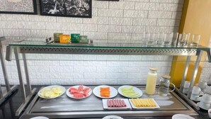 A buffet counter with various food items and condiments. - Star Hotel (Limoeiro)