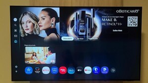 A television screen displaying a skincare advertisement and a video streaming interface. - Star Hotel (Limoeiro)
