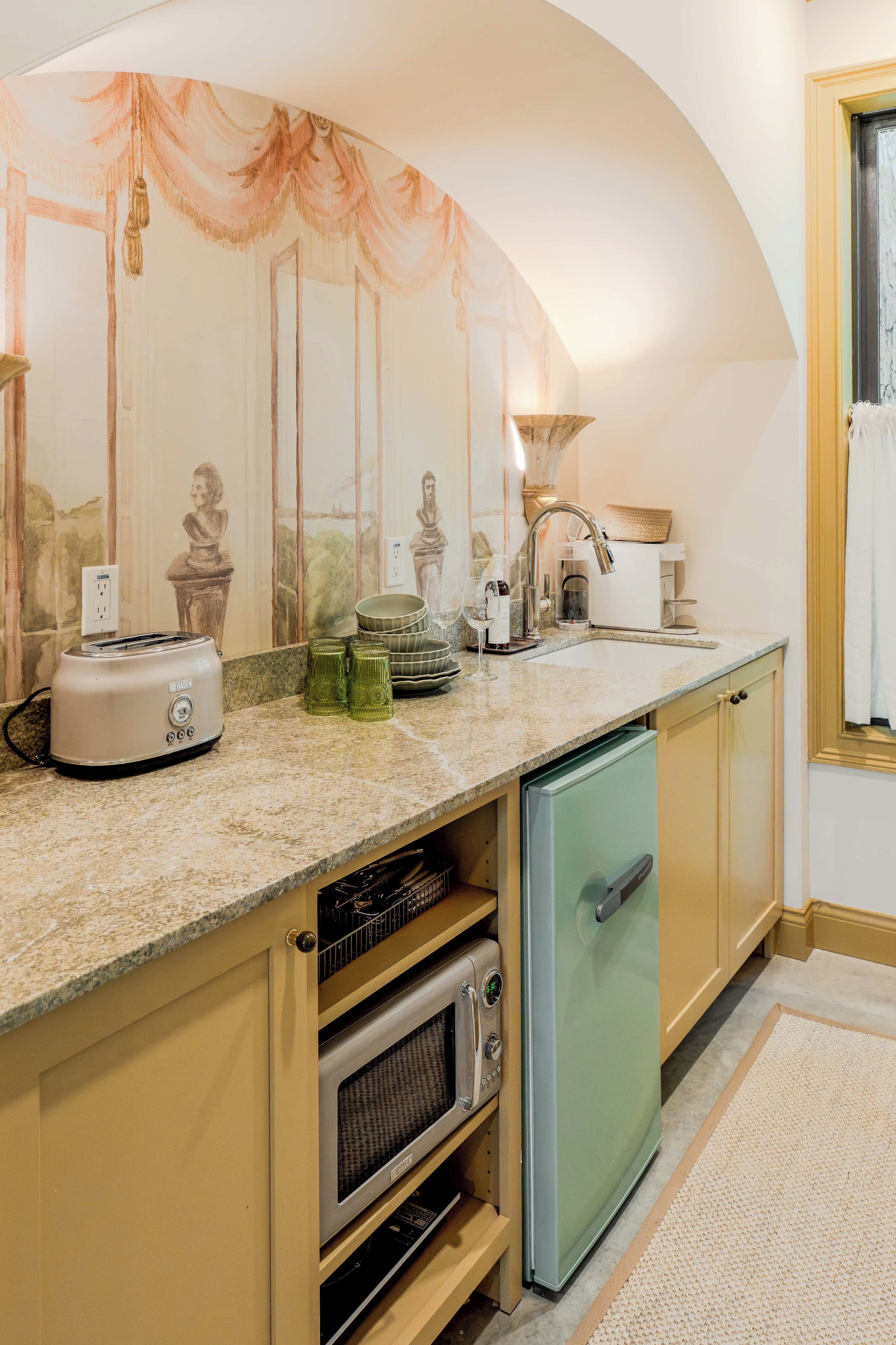 A kitchen with a built-in oven, a dishwasher, and a sink.