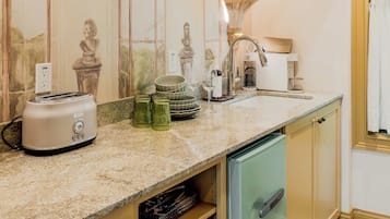 A kitchen with a built-in oven, a dishwasher, and a sink.