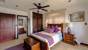 A bedroom with a bed, bedside table, lamp, and a ceiling fan. -  Beach front condo Jaco Tres Regalos  3 bedrooms 4th floor beautiful ocean views (Jaco)