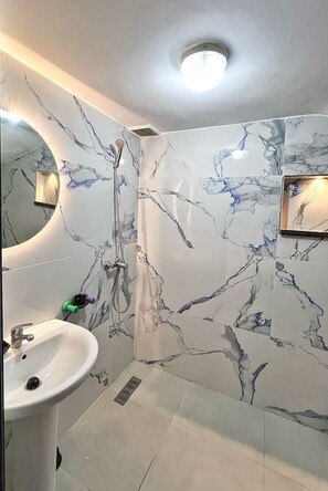 Shower, hair dryer, towels, toilet paper