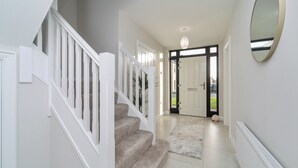 A staircase with white railings leading to a door. - Modern Entire Home Retreat in Newry (Newry)