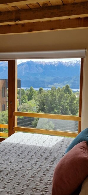 A bedroom with a large window offering a mountain view. - Lomas Schuss ARG41 (San Carlos de Bariloche)