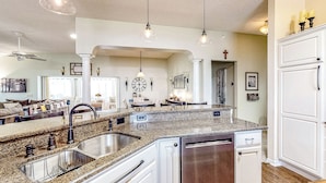 A spacious kitchen with granite countertops, stainless steel appliances, and pendant lighting. - 1 Mi to Lake Sumter! Family Retreat w/ Large Patio (The Villages)