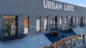 A building with the sign "URBAN LOFTS" and multiple windows. - Downtown Urban Loft #4 (Perryville)