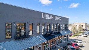 A building with a sign reading "URBAN LOFTS" and a storefront below. - Downtown Urban Loft above Restaurants (Perryville)