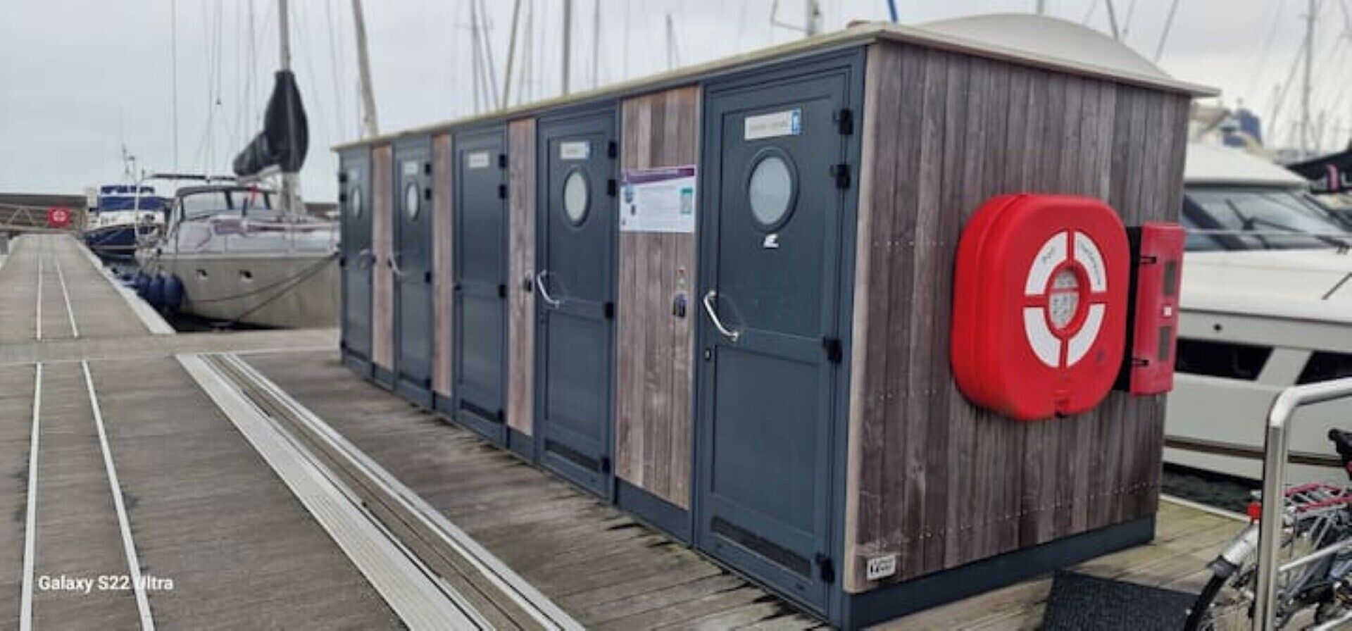 A row of dark-colored utility cabinets with a red circular sign on the right.