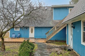 A blue house with a porch, two Adirondack chairs, a stone pathway, and a wooden staircase. - Chautauqua Lake Views! Bemus Point Getaway (Bemus Point)