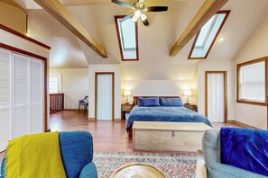 A spacious bedroom with a large bed, a ceiling fan, and skylights. - Chautauqua Lake Views! Bemus Point Getaway (Bemus Point)