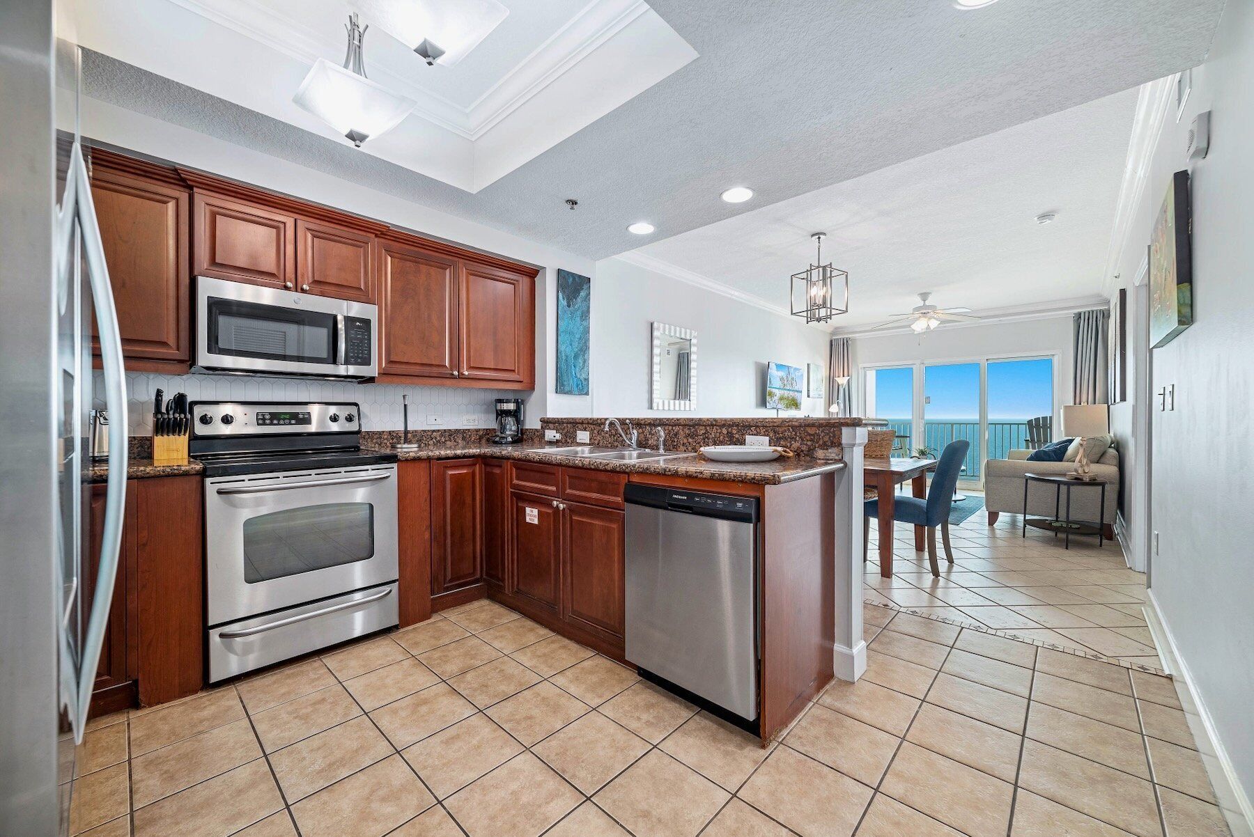 A modern kitchen with stainless steel appliances, wooden cabinets, and a large island.