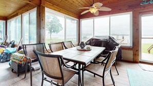 A wooden interior with a dining table, chairs, and a ceiling fan. - Waterfront Home on Lake Limestone w/ Dock (Groesbeck)