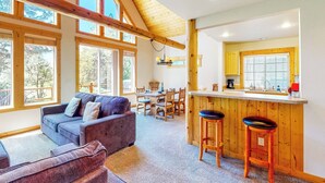 A cozy interior with a sofa, dining area, and kitchen. - Gateway to Crater Lake! Resort Retreat w/ Pool (Klamath Falls)