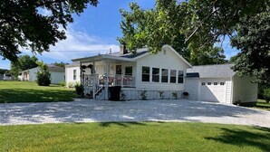 A single-story house with a front porch, a garage, and a well-maintained lawn.