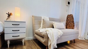 A bedroom with a bed, a nightstand, and a dresser.