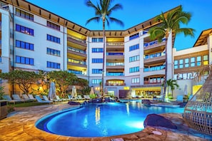 A hotel with a swimming pool, multiple balconies, and palm trees. - Wailea Beach | Oceanfront 6 BR, Sleeps 12 | Car Incl. w/ 6+ Nights | WBV ML-3485 by KBM (Wailea)