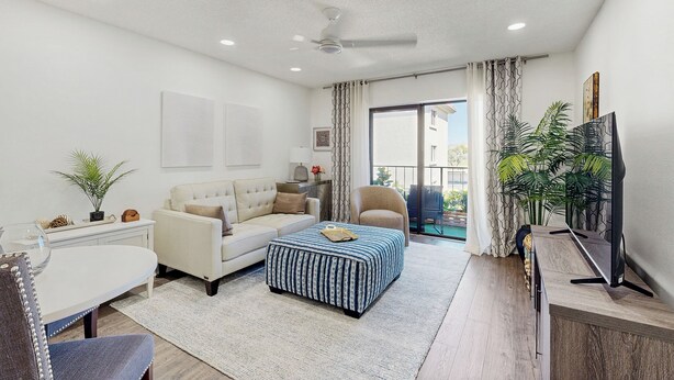 A modern living room with a sofa, ottoman, TV, and a dining area. - Mtn-View Balcony: Condo 6 Mi to Dtwn Phoenix (Phoenix)