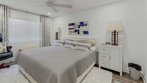 A bedroom with a bed, a ceiling fan, a nightstand with a lamp, a wall art piece, and a trash bin. - Mtn-View Balcony: Condo 6 Mi to Dtwn Phoenix (Phoenix)
