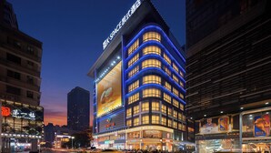A multi-story hotel with a prominent sign for 'Space Hotel' and a large advertisement for 'Chaggee.' - K·SPACE Hotel - Guangzhou Beijing Road Dafo Ancient Temple Branch (Guangzhou)