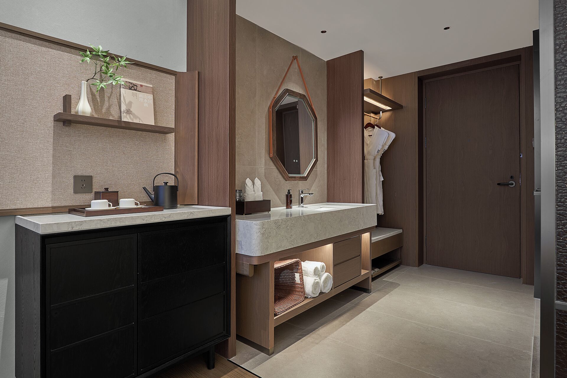 A modern bathroom with two sinks, a large mirror, and a towel rack.