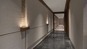 A long, narrow hallway with textured walls and a marble floor. - K·SPACE Hotel - Guangzhou Beijing Road Dafo Ancient Temple Branch (Guangzhou)
