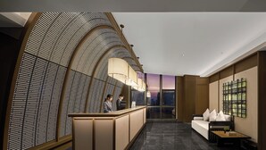 A modern lobby with a reception desk, a seating area, and a large window offering a city view. - K·SPACE Hotel - Guangzhou Beijing Road Dafo Ancient Temple Branch (Guangzhou)