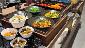 A buffet with various food options, including bowls of food, trays of fruits, and containers of beans. - K·SPACE Hotel - Guangzhou Beijing Road Dafo Ancient Temple Branch (Guangzhou)