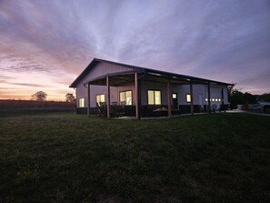 Exterior - Modern home on acreage with pond, trails, rolling hills, and sunset views (Winterset)