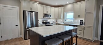 Modern home on acreage with pond, trails, rolling hills, and sunset views