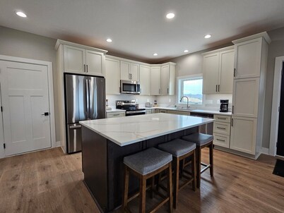 Modern home on acreage with pond, trails, rolling hills, and sunset views