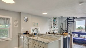 A kitchen with a granite countertop, wooden cabinets, a built-in sink, and a window with a view. - Coastal York Gem Near Beach: Work, Play & Explore! (York)