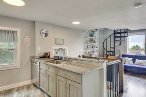 A kitchen with a granite countertop, wooden cabinets, a built-in sink, and a window with a view. - Coastal York Gem Near Beach: Work, Play & Explore! (York)