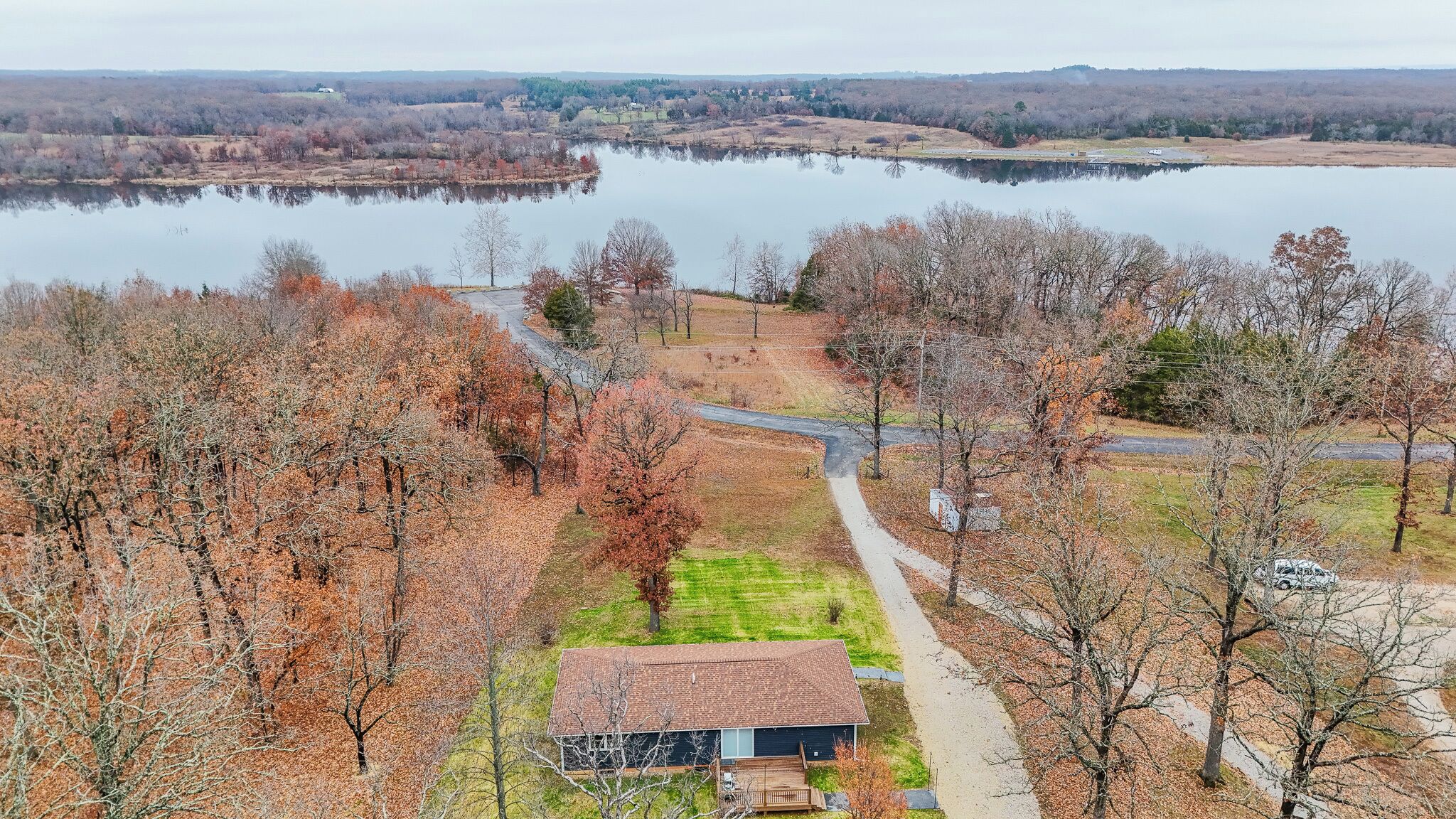 A rural property with a house, a pond, and a road.