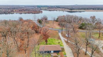 A rural property with a house, a pond, and a road.