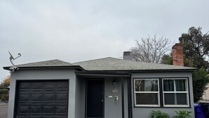A single-story house with a garage, a front door, and a small porch.