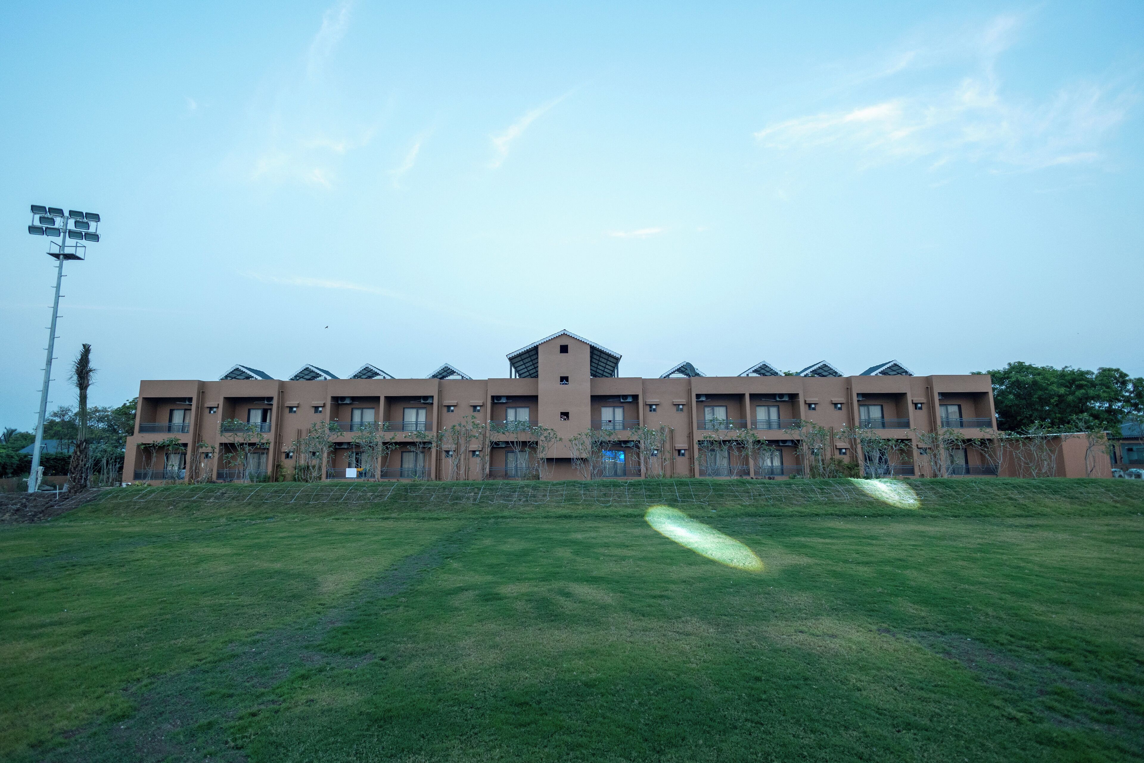 A multi-story hotel with a flat roof and multiple balconies.