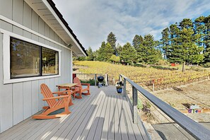 A wooden deck with Adirondack chairs and a grill, overlooking a vineyard. - Mtn-View Retreat w/ Hot Tub + Deck in Sebastopol (Sebastopol)