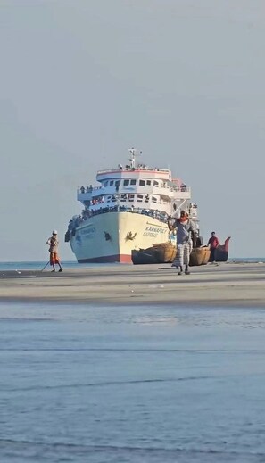 A large ship with the name "Karnafly Express" docked at a port. - Shimana Periye Resort SaintMartin Island (Saint Martin's Island)