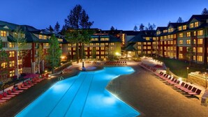 A hotel with a large swimming pool, multiple guest rooms, and outdoor seating areas. - 2-bedroom hotel suites walking distance to Heavenly Gondola (South Lake Tahoe)