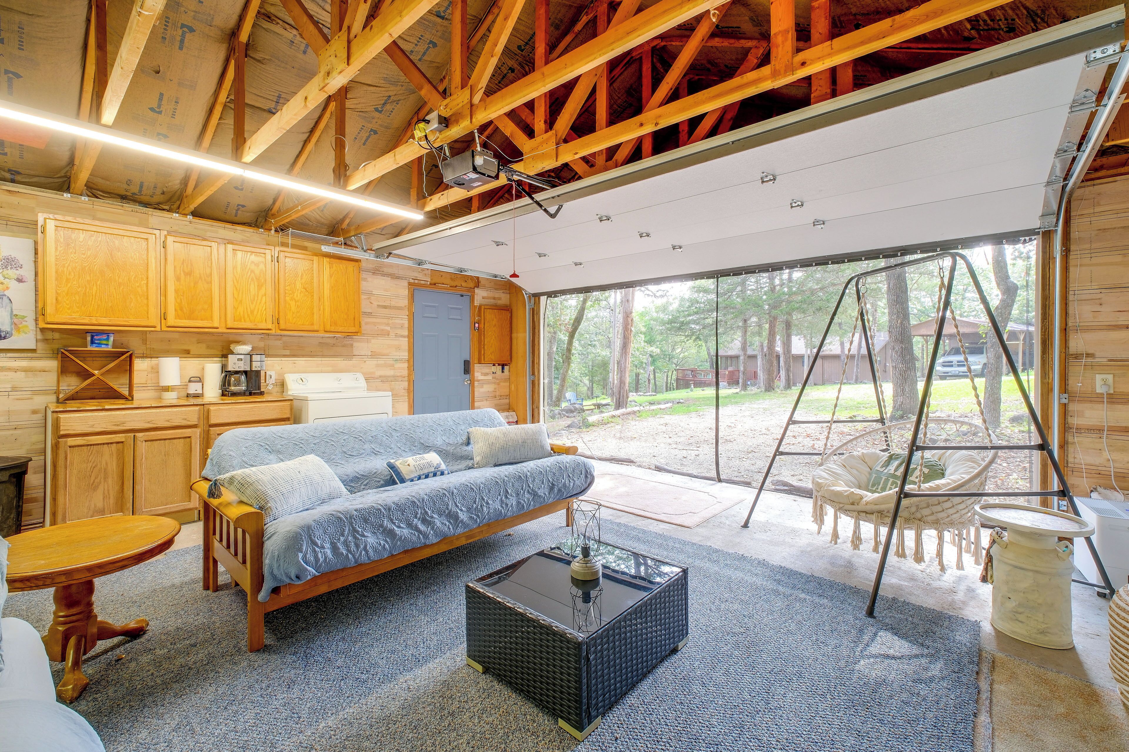 A cozy living room with a sofa, coffee table, and a swing chair.