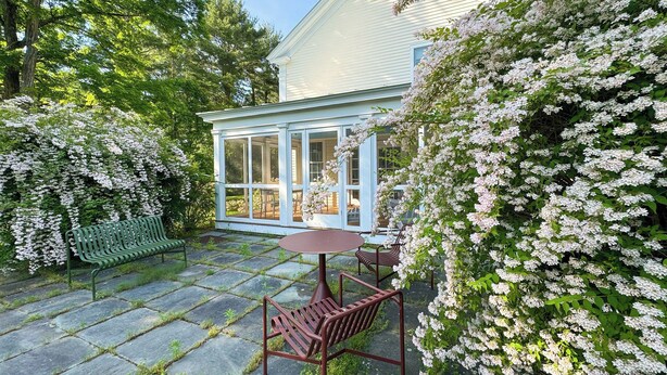 A covered patio with a stone floor, a wooden bench, a table, and chairs. - Close to Copake Lake! 4-Season Escape w/ Sauna (Copake)