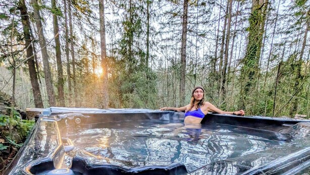 A hot tub in a forested area.