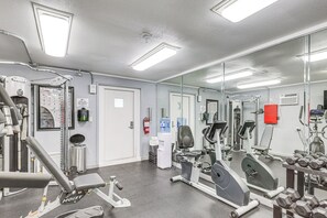 A gym with exercise equipment, a water dispenser, and a mirror. - Gulf Views, Resort Perks: Suntide III - Unit 703 (South Padre Island)